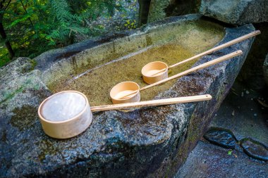 Purification fountain at a Shrine in Arashiyama, Kyoto, Japan clipart