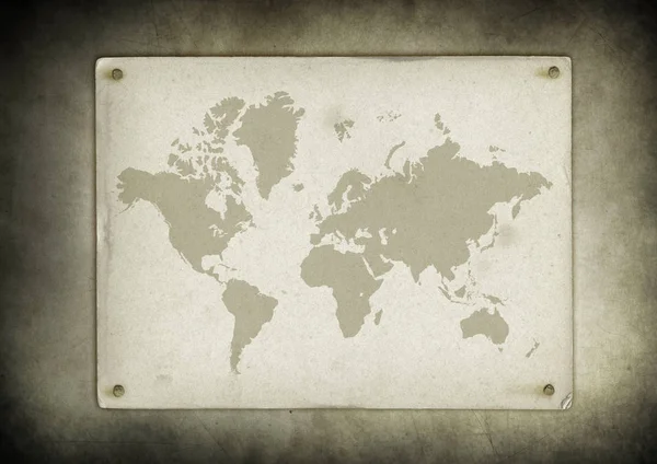 Винтажный пергамент карты мира, прибитый к стене — стоковое фото