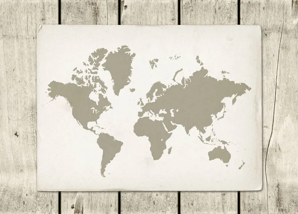 Vintage world map parchment on a wooden wall — Stock Photo, Image