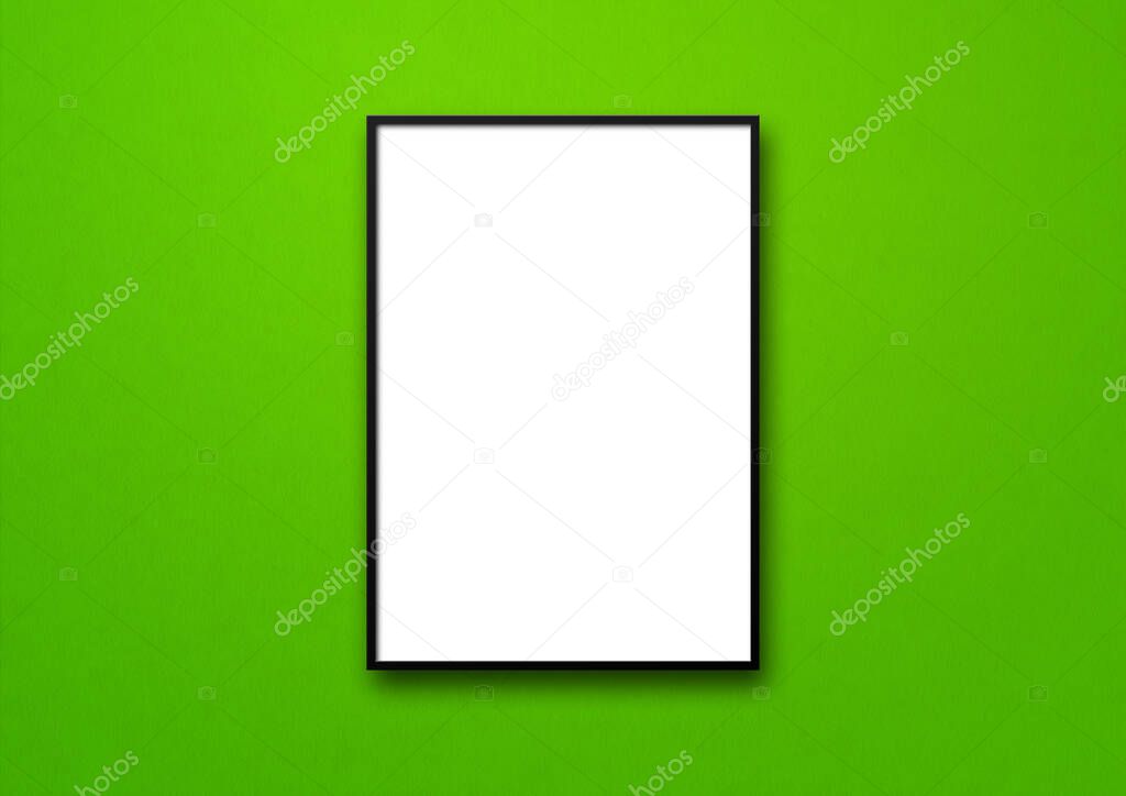 Black picture frame hanging on a green wall. Blank mockup template