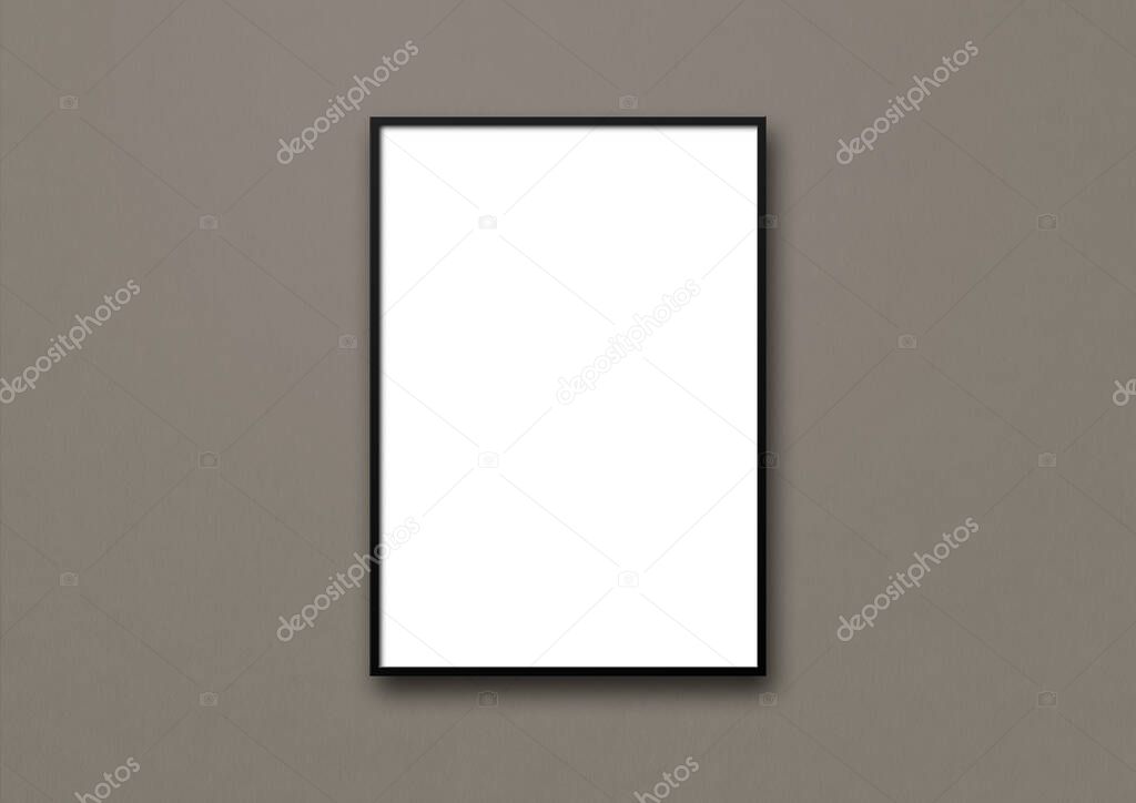 Black picture frame hanging on a dark grey wall. Blank mockup template
