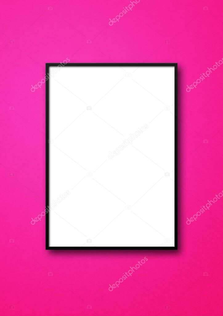 Black picture frame hanging on a pink wall. Blank mockup template