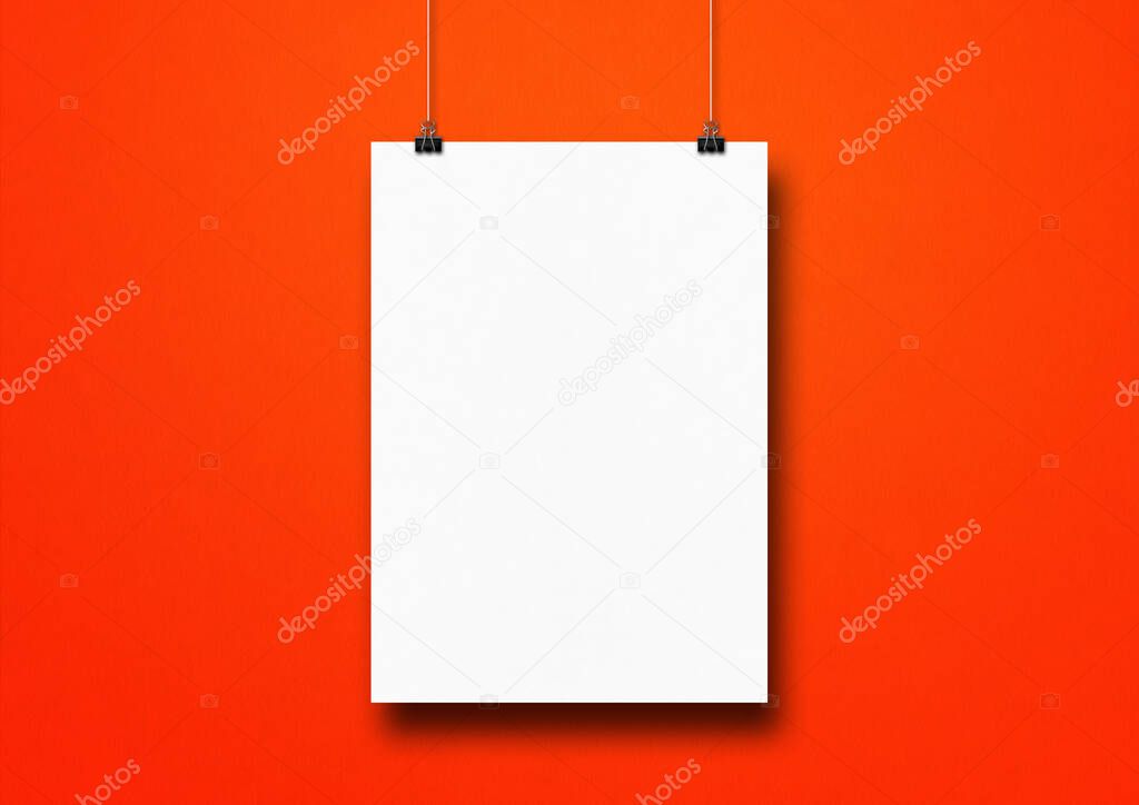 White poster hanging on a red wall with clips. Blank mockup template