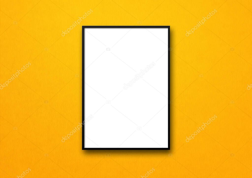 Black picture frame hanging on a yellow wall. Blank mockup template