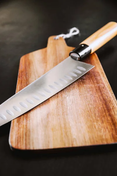 Traditional Japanese gyuto chief knife on a cutting board.