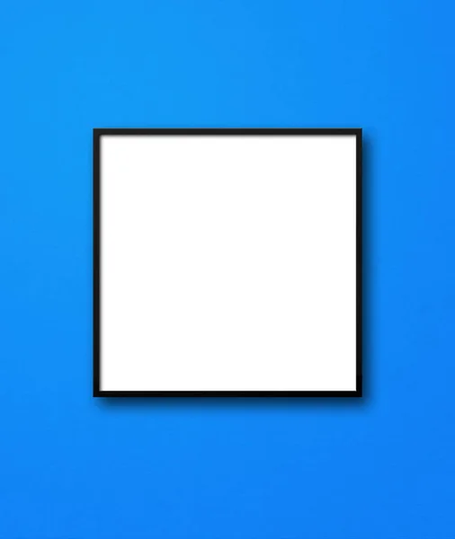 挂在蓝色墙上的黑色正方形相框 空白模型模板 — 图库照片