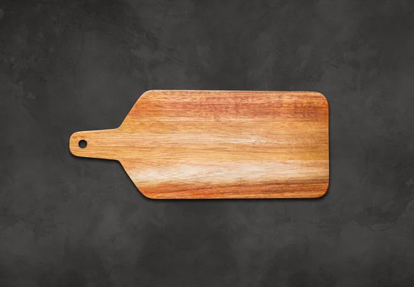 Wooden cutting board on concrete table background