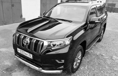 BIYSK, RUSSIA - MAY 16, 2020: Toyota Land Cruiser Prado, 2017. Car parked in a parking space. Black and white photography. 