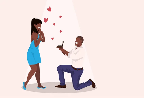 Man kneeling holding engagement ring proposing to surprised woman marry him happy valentines day concept african couple in love marriage offer full length horizontal — Διανυσματικό Αρχείο