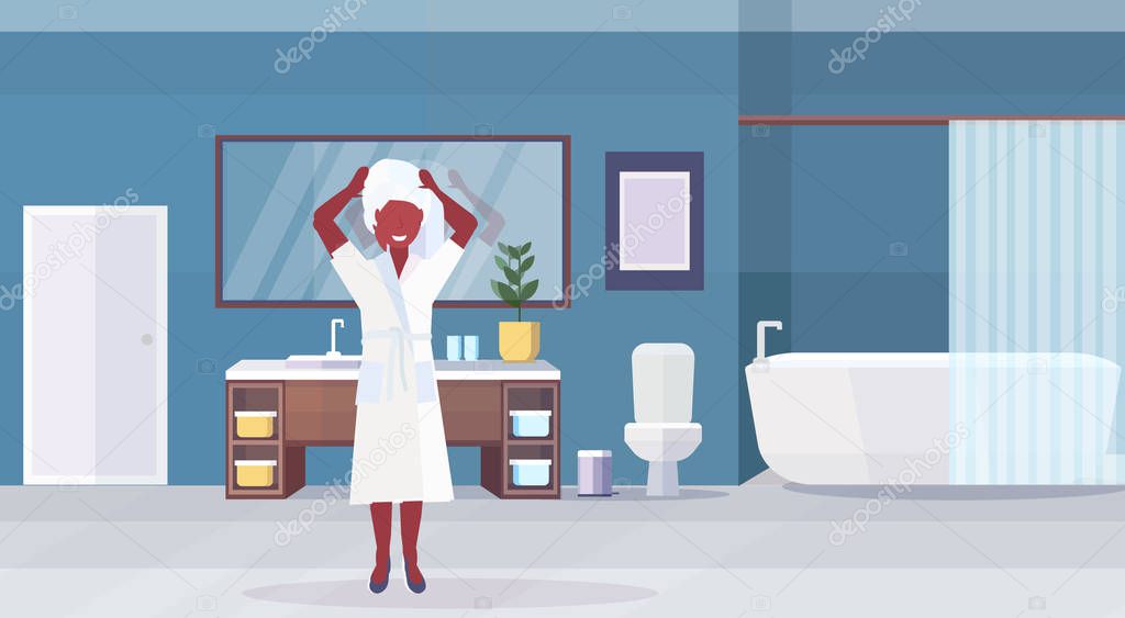 woman wearing white bathrobe and towel on head african american girl standing modern bathroom interior flat horizontal full length flat