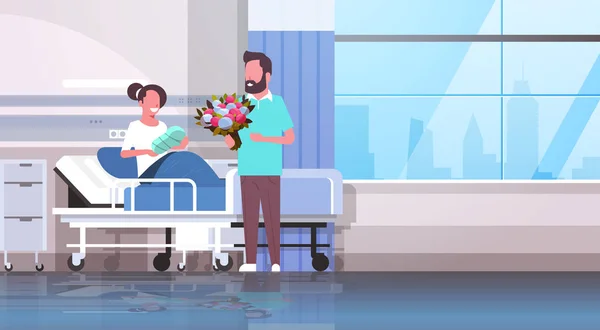 Husband holding flowers bouquet for his wife with newborn baby sitting on bed loving father visiting new born child happy family parenthood concept hospital ward interior horizontal — Stock Vector