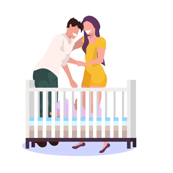 Happy couple parents standing near baby crib husband with wife embracing and looking at newborn baby lying in cot parenthood concept flat full length — Stock Vector