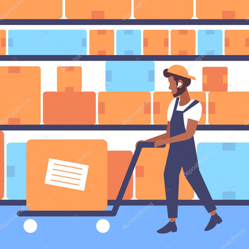 warehouse worker in uniform pulling trolley hand truck with cardboard box african american man working modern logistic storage industry commercial business concept horizontal flat