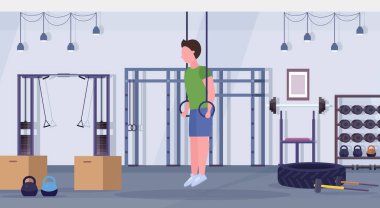 Ring yapan sportif erkek egzersizleri kardiyo crossfit egzersiz kavramı modern bir spor salonu sağlık kulübü studio iç yatay tam uzunlukta eğitim jimnastik yüzük adamla dips.