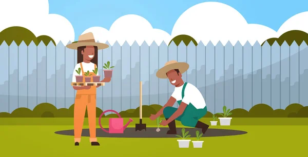 Couple farmers planting young seedlings plants flowers and vegetables african american man woman working in garden eco farming concept backyard background full length horizontal — Stock Vector