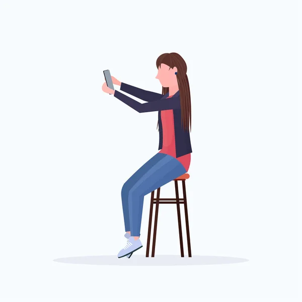 Woman taking selfie photo on smartphone camera blonde female cartoon character sitting on chair posing on white background flat full length — 스톡 벡터