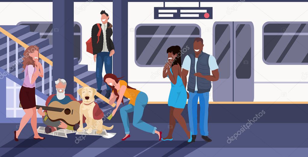 beggar sitting with dog train subway railway underground station mix race passengers giving money to beggar man playing guitar homeless jobless concept horizontal full length