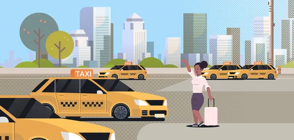 Businesswoman catching taxi on street african american business woman with luggage stopping yellow cab city transportation service concept cityscape background full length flat horizontal — Stock Vector