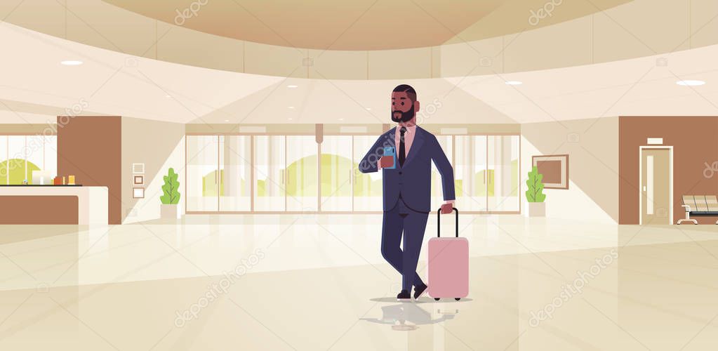 businessman with luggage modern reception area african american business man holding suitcase guy standing in lobby contemporary hotel hall interior flat horizontal full length