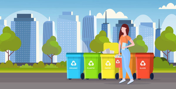 womanputting bucket with paper rubbish in container different types of recycling bins segregate waste sorting management concept modern cityscape background flat horizontal full length