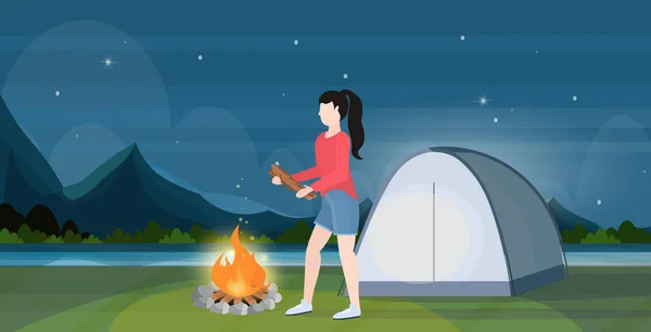 Woman hiker making fire girl holding firewood for bonfire hiking camping concept traveler on hike beautiful night landscape background horizontal full length flat — 스톡 벡터