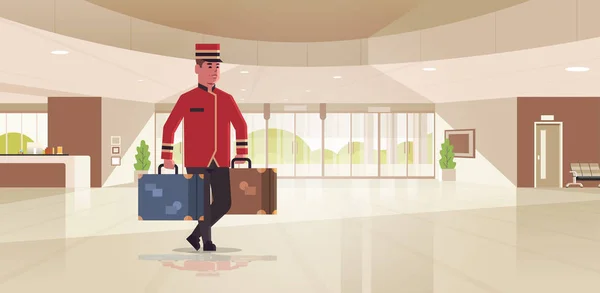 Κουδούνι που μεταφέρει βαλίτσες ξενοδοχείο υπηρεσία concept γκρουμ Holding αποσκευές αρσενικό εργαζόμενο σε ομοιόμορφη μοντέρνα χώρο υποδοχής λόμπι εσωτερικό πλήρες μήκος οριζόντια επίπεδη — Διανυσματικό Αρχείο