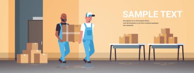 üniforma taşıyan iki kurye karton kutu paketi posta ekspres teslimat hizmeti kavramı karışımı yarış sanayi fabrika işçileri depo da çalışan depo düz tam uzunlukta yatay