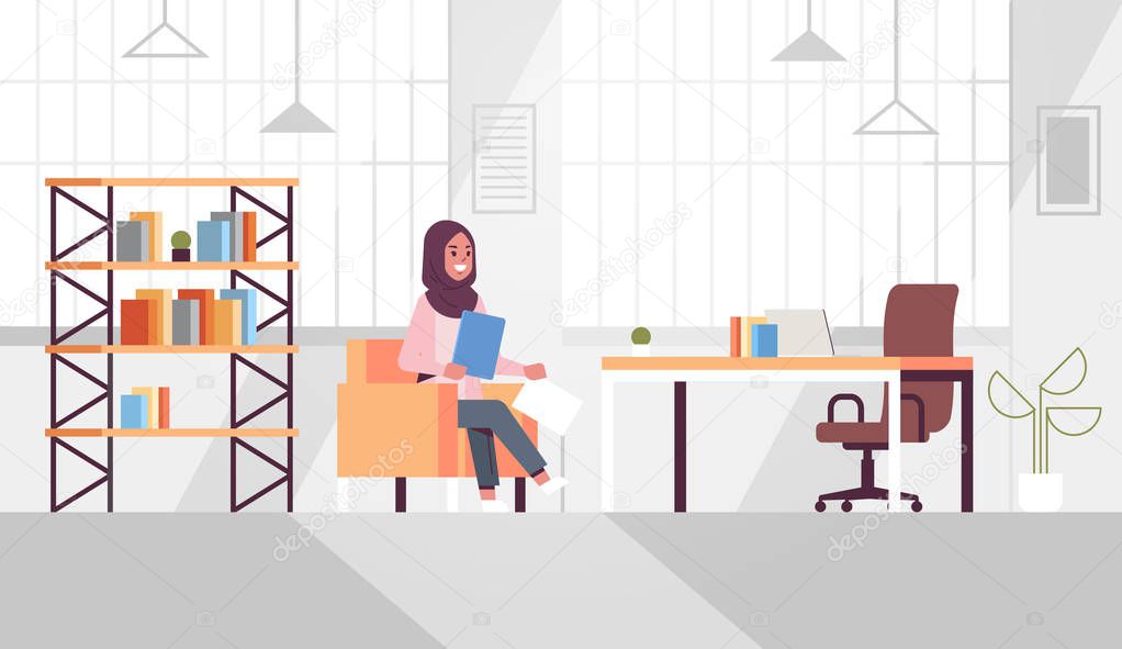 arabic businesswoman sitting at workplace desk arab business woman holding paper documents preparing report working process concept modern office interior flat horizontal