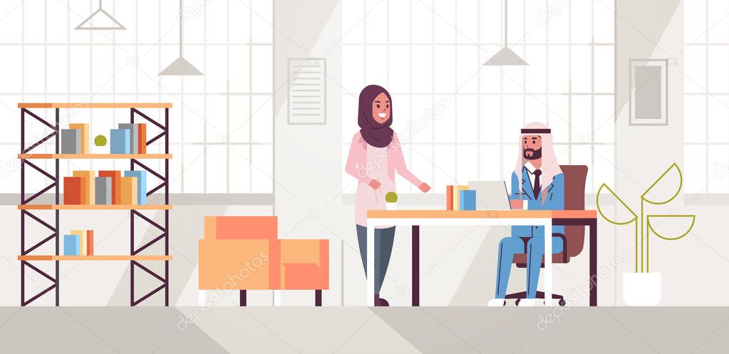 arab businessman with female assistant using laptop discussing new project during meeting at workplace teamwork concept creative workspace modern office interior flat full length horizontal