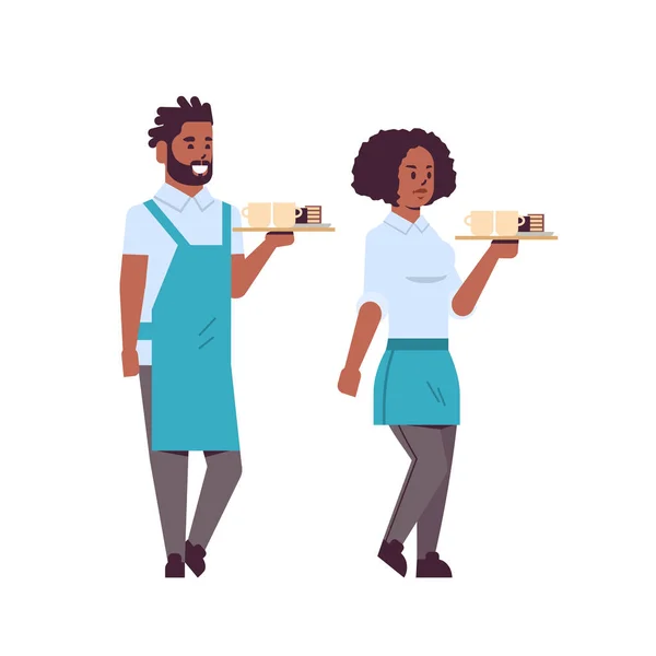 Professional waiters couple holding coffee and cake on tray african american man woman restaurant workers in apron serving food concept flat full length white background — Stock Vector