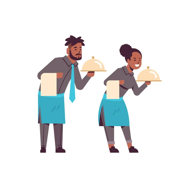 Professional waiters couple holding dish african american man woman restaurant workers in uniform with tray and towel food serving concept flat full length white background — Stock Vector