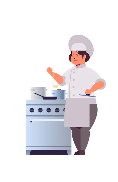 Female professional chef cook preparing and tasting dishes woman restaurant worker in uniform near kitchen stove cooking food concept flat full length vertical — Stock Vector