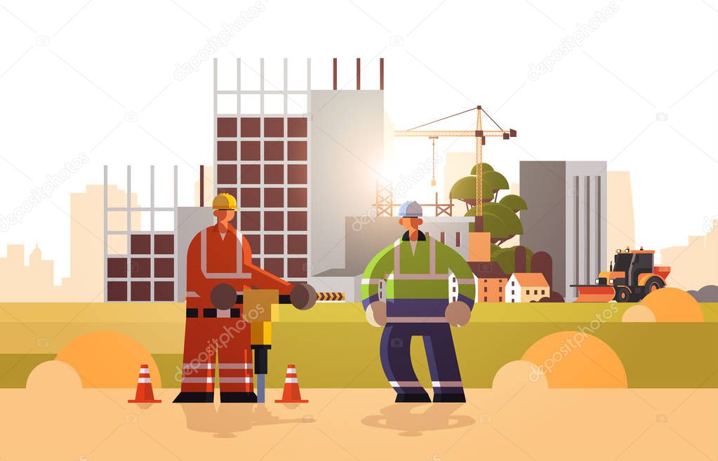 builders couple drilling with jackhammer wearing hard hat busy workmen working together industrial workers in uniform building concept construction site background horizontal flat full length