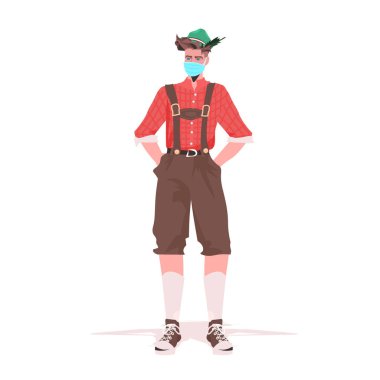 Koronavirüs salgınını önlemek için maske takan geleneksel kıyafetli bir adam Oktoberfest parti kutlamasını engelliyor.