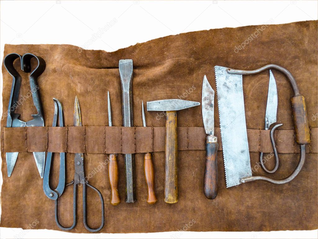 A set of medical medieval surgery tools in a leather casing