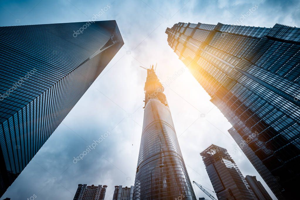 Three skyscrapers with Shanghai Tower on the right under construction in Lujiazui financial district, in Pudong, Shanghai, China.