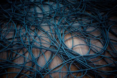 Ahşap zemin üzerinde renkli kablolar ağ kaos.