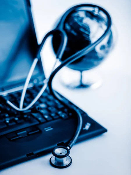 Electronic medical, stethoscope on Laptop blue toned images.
