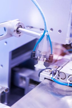 Vakumlu robotlar üretim fabrikasındaki konveyörden bir şey seçiyor.