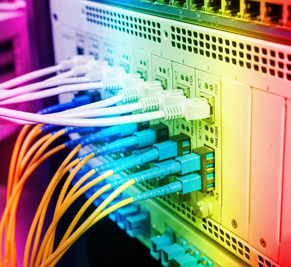 Fiber Optic cables connected to optic ports and UTP, Network cables connected to ethernet ports.