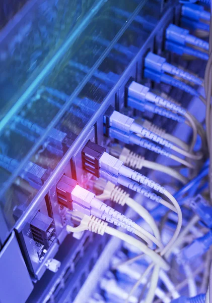 Fiber Optic cables connected to an optic ports and Network cables connected to ethernet ports