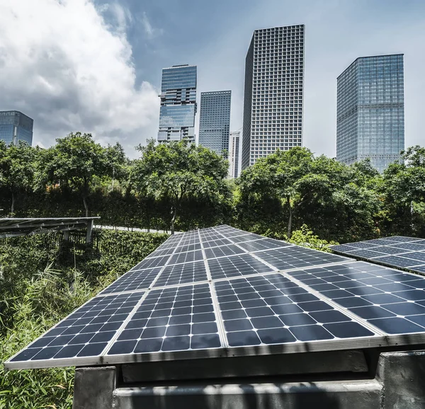 Solar panels with cityscape of modern city,Ecological energy ren — Stock Photo, Image