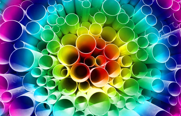 Color rainbow of PVC pipes stacked in construction site — Stock Photo, Image