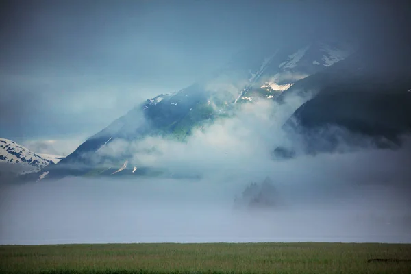 Picturesque Mountains of Alaska in summer. Snow covered massifs, glaciers and rocky peaks.