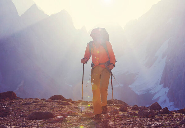 Wanderlust time. Man hiking in beautiful Fann mountains in Pamir, Tajikistan. Central Asia.