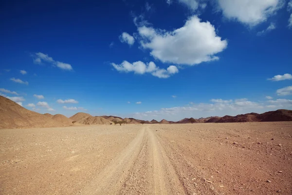 Safari and extreme travel in Africa. Drought  mountain landscape with dust off road in offroad car expedition.