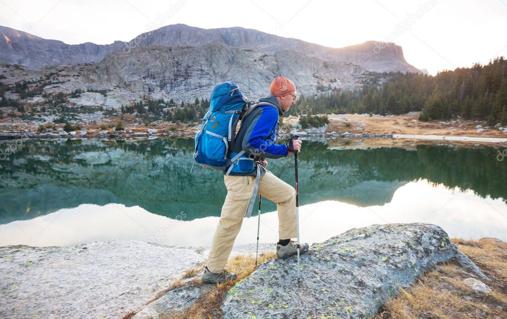 Backpacker in a hike in the summer mountains