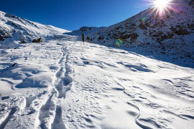 Kış dağlarında yürüyüşçüler