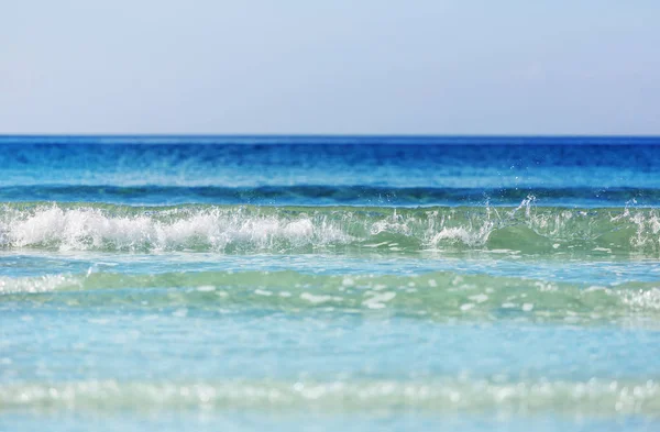 Une Vague Bleue Sur Plage Fond Flou Taches Lumière Soleil — Photo