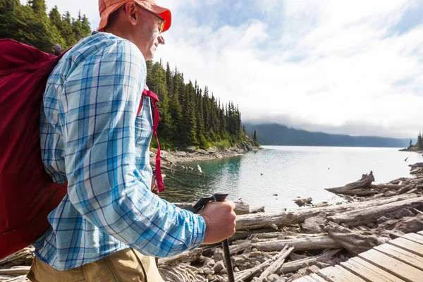 Hiking man in Canadian mountains. Hike is the popular recreation activity in North America. There are a lot of picturesque trails.